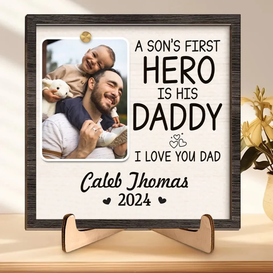 Custom Photo A Son's First Hero Is His Daddy - Family Personalized Custom 2-Layered Wooden Plaque With Stand - Gift For Dad 1 Custom Photo A Son's First Hero Is His Daddy - Family Personalized Custom 2-Layered Wooden Plaque With Stand - Gift For Dad